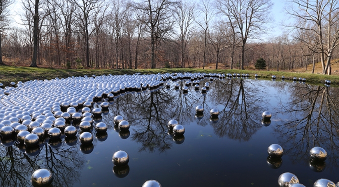 Yayoi Kusama floats a landscape of 1,300 mirrored spheres at the glass house